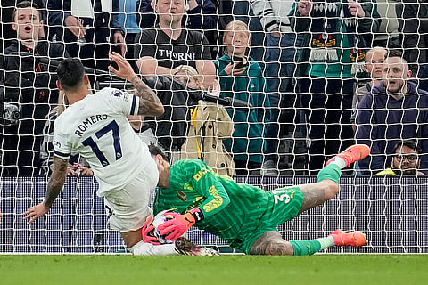 Cristian Romero and City's goalkeeper Ederson challenge for the ball